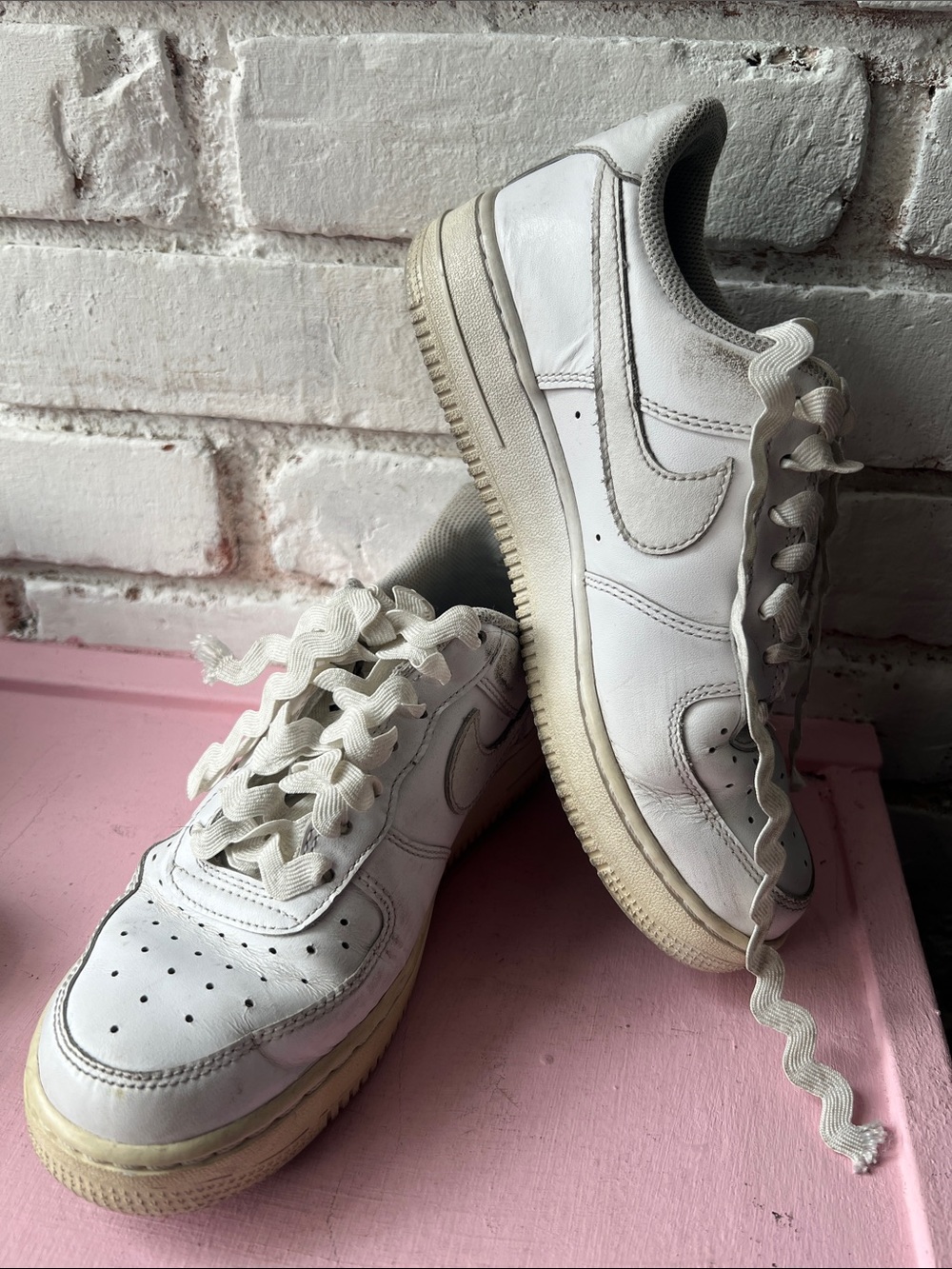 Nike White Leather Low-Top Sneakers with Cream Soles well worn